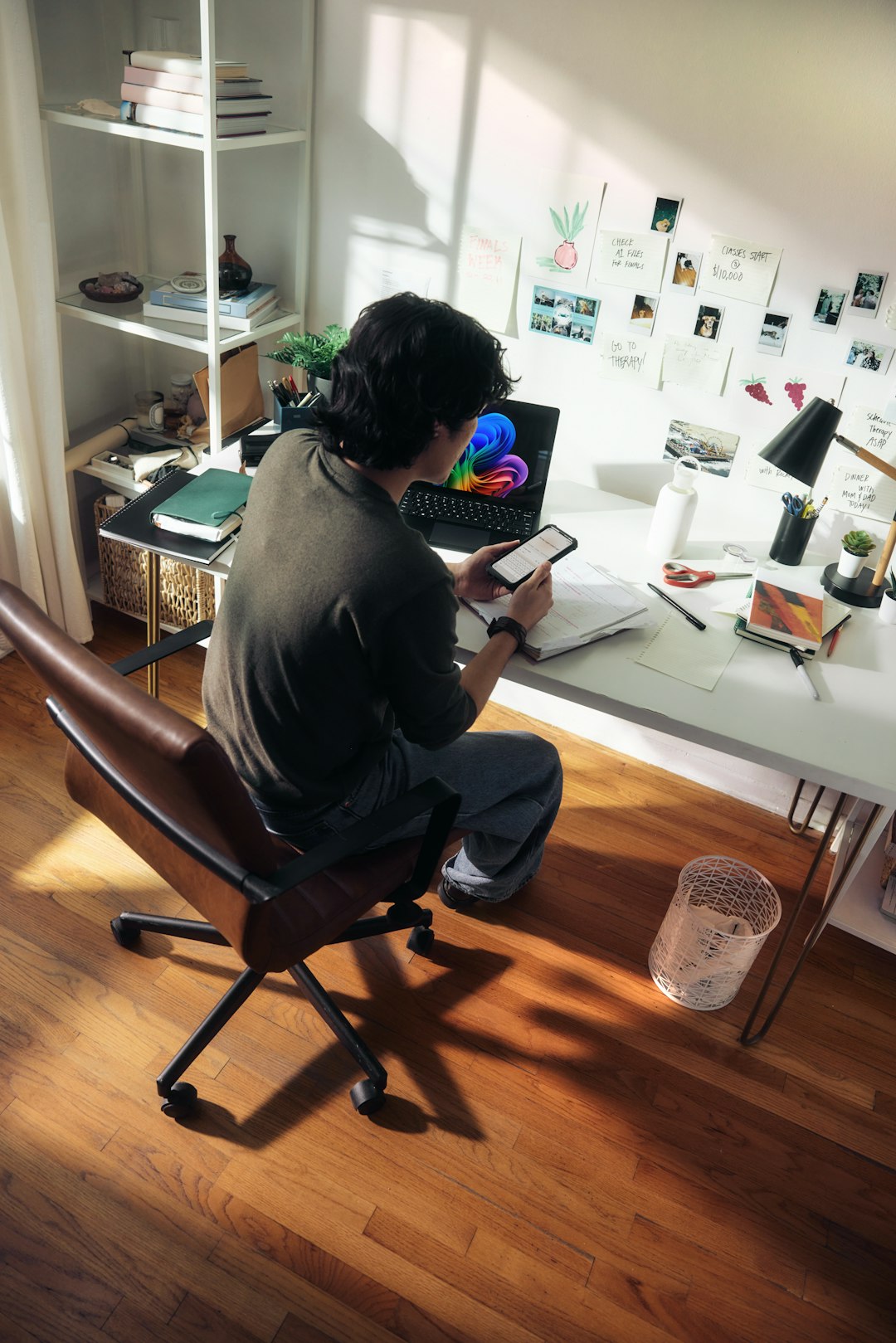 man-working-at-desk-with-laptop-and-phone-pqmpnpo4-za